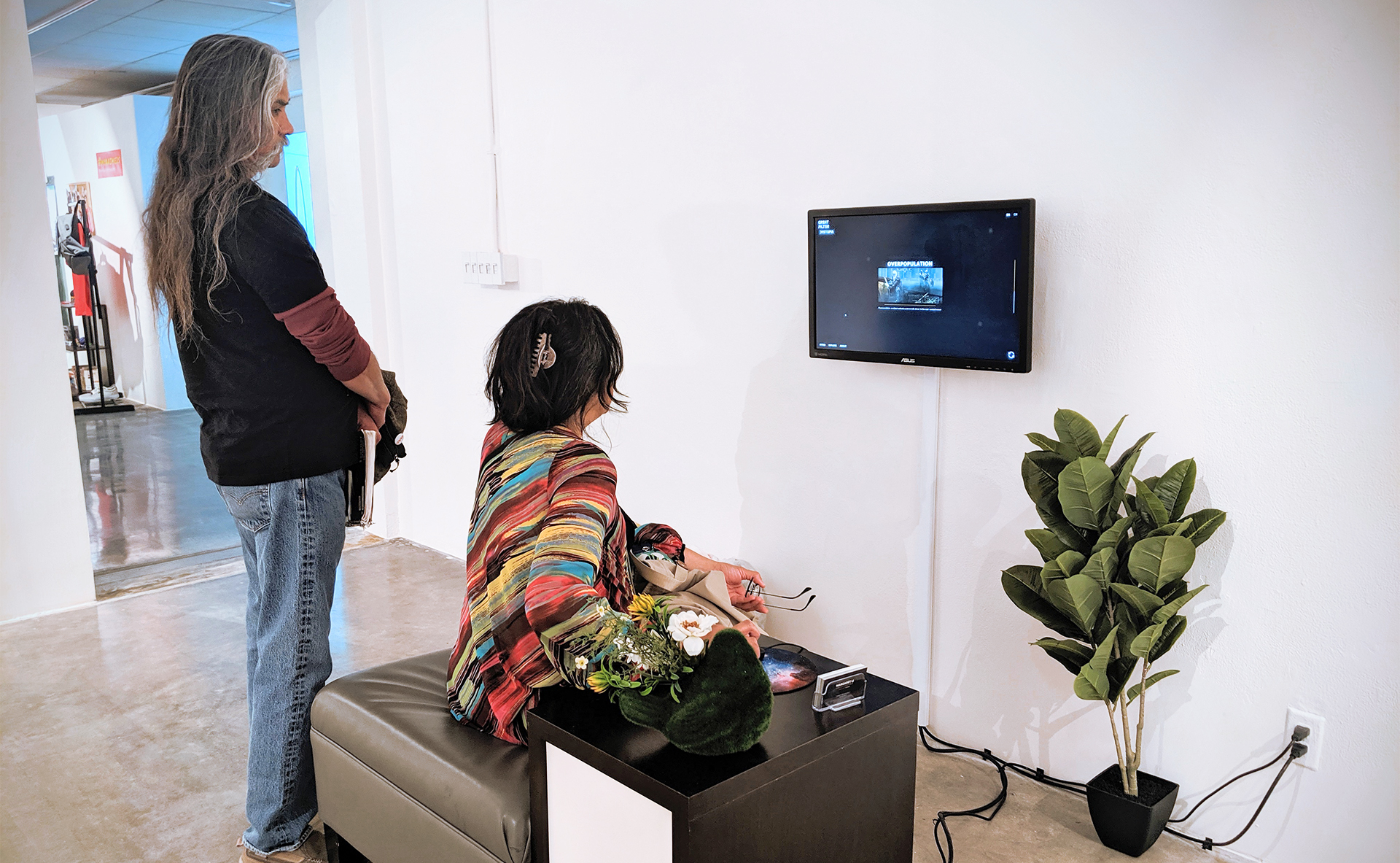 Visitors engaging with the Great Filter digital installation in a gallery setting.